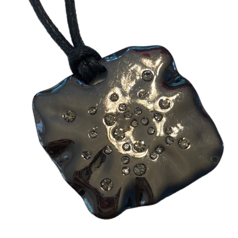 Gunmetal Tone pendant wit embedded crystal on leather cord